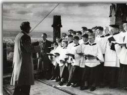 William Shenton, choirmaster, directs the choir at the tower top - Click to Enlarge