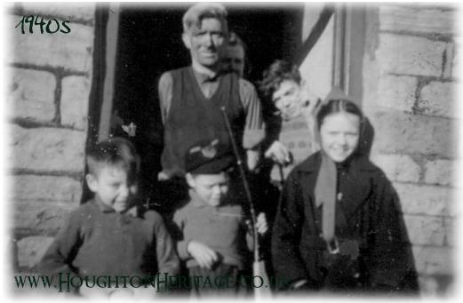 A game of cricket on Hawthorn Street, with the back yards of North Row opposite