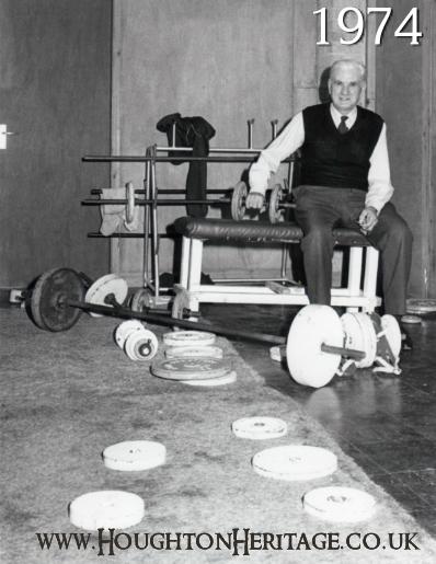 Weightlifting equipment in one of the rooms of Houghton YMCA at Houghton Hall, 1974.  Pictured is Joe Green the caretaker.