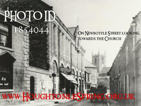 On Newbottle Street, looking towards St Michael's Church.  Note the buildings on the left which were the old Town Hall and Covered Market.  The building on the far left, of which we can see a window with a triangle adornment above it, is the Newcastle Arms public house.